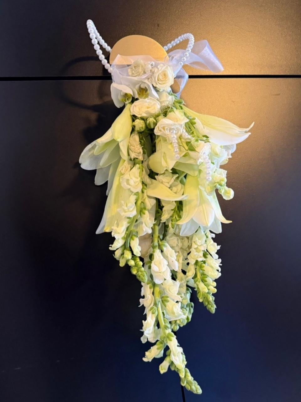 Cascading white garland of orchids and lilies